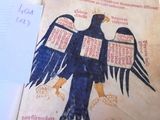 an open book with a drawing of a bird on it