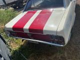 a red and white striped car parked on the side of the road