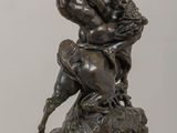 bronze statue of a man on a horse with a trumpet in his hand