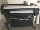 a large black and white printer sitting on a stand