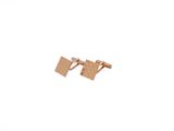 pair of wooden cufflinks on white background with sky in background