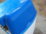 a blue and white cooler sitting on the ground