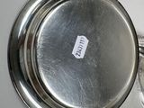 a silver plate with a tag on it sitting on a table