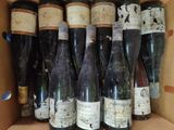 many bottles of wine sitting in a box together