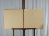 a wooden easel with a piece of paper on top of it