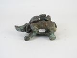 a small statue of a turtle with two birds on its back