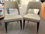 two chairs sitting next to each other in a room