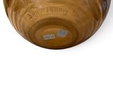 a brown vase that is sitting on a white surface