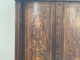 a wooden armoire with intricate carvings on it