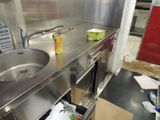 a kitchen with a sink and a trash can