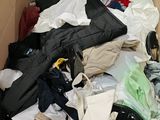 a cardboard box filled with clothes and a pair of scissors