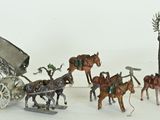 a lot of figurines of horses pulling a carriage