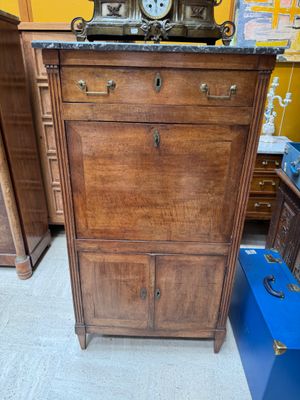 a dresser with a clock on top of it in a room