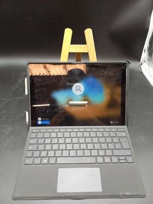 a laptop computer sitting on a table with a wooden easer