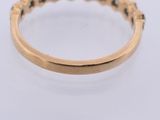 a close up of a gold ring on a white surface