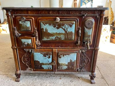 a wooden cabinet that has a painting on it
