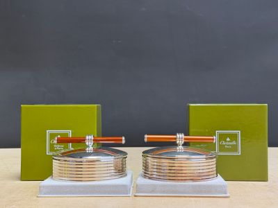 pair of silver plated ashtrays with wooden handles and a green box