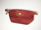 a red leather purse with a gold clasp on it