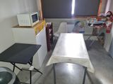 an image of a kitchen with a table and a microwave