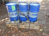 three blue barrels sitting on top of a wooden pallet
