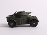 a toy army vehicle that is on a white surface