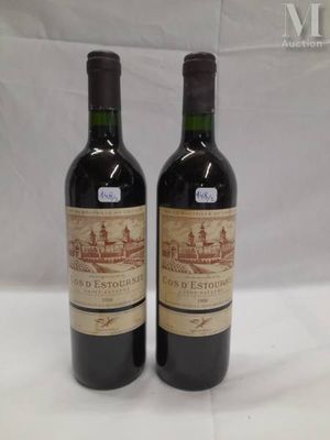 two bottles of wine sitting on top of a white table