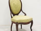 une chaise dont l'assise est recouverte d'un tissu jaune