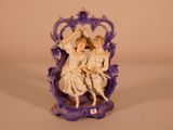 a figurine of two people sitting on a bench