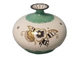 a white and green vase with a flower design on it