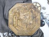 a gold plate with a picture of a man and a woman on it