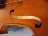 a close up of a violin that is on a table