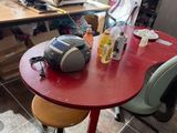 a red table with two chairs and a microwave on it
