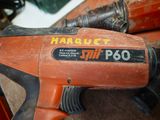 an orange and black power drill sitting on a table