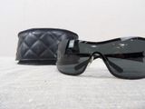 a pair of sunglasses sitting on a table next to a purse