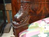 a wooden chair with a floral upholstered upholstered seat