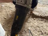 a person using a cordless drill to fix a hole in the ground