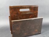 an image of a magazine holder with a handle on a gray background