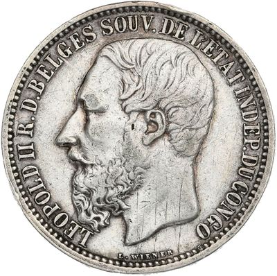 a close up of a coin with a man ' s face on it