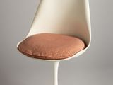 an image of a white chair with a pink cushion on it