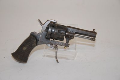 an old revolver with a wooden handle on a white surface