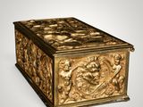 an ornate gold casket with chers and angels on it