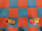 a lot of small toys on a checkered board