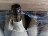 two bottles of wine wrapped in plastic in a box