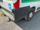 a white van with a green stripe parked on the side of the road