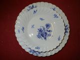 two plates with blue flowers on them on a red table