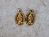 a pair of gold plated virgin medal charms