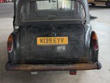 an old car that is parked in a garage