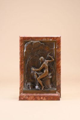 an image of a sculpture of a woman sitting on a rock