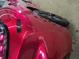 a red car that is parked in a garage
