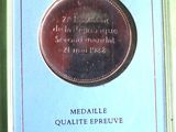a medal in a blue box on a green surface